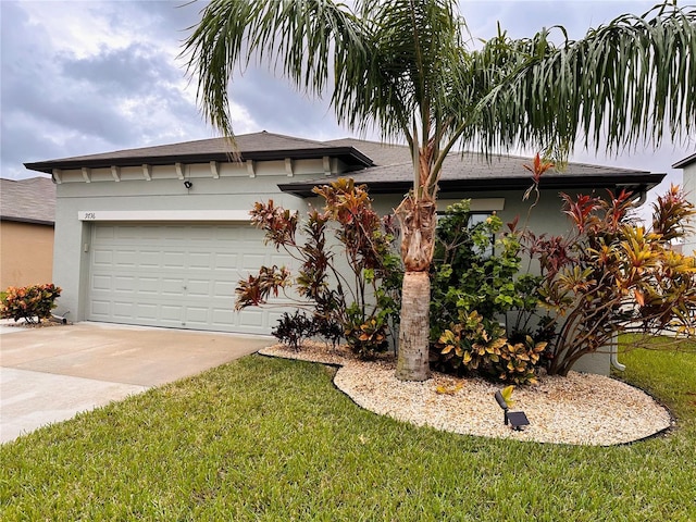 view of front of property featuring a front yard and a garage