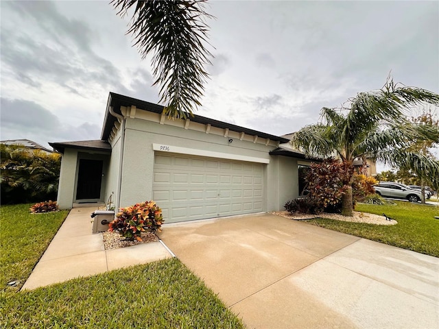 view of front of house with a garage and a front lawn