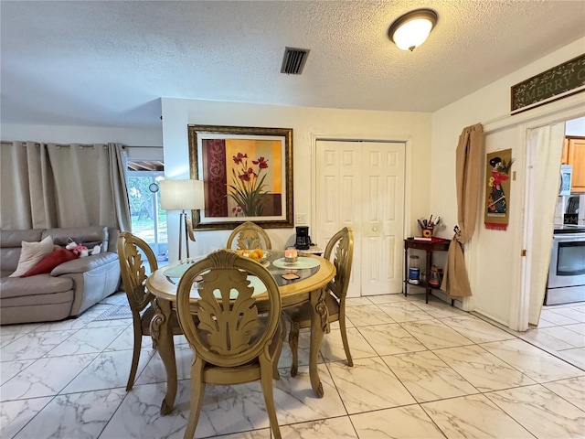 dining room with a textured ceiling