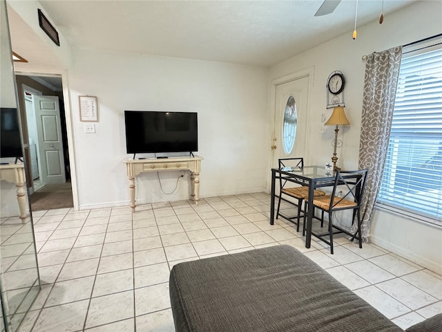 living room with ceiling fan, plenty of natural light, and light tile patterned flooring