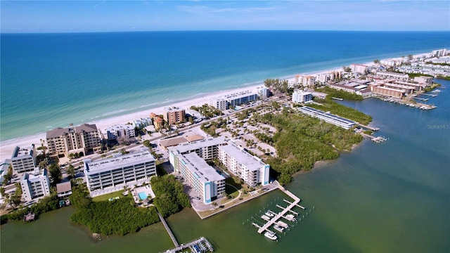 bird's eye view featuring a water view and a beach view