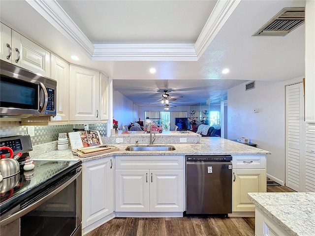 kitchen featuring stainless steel appliances, white cabinetry, ornamental molding, and sink