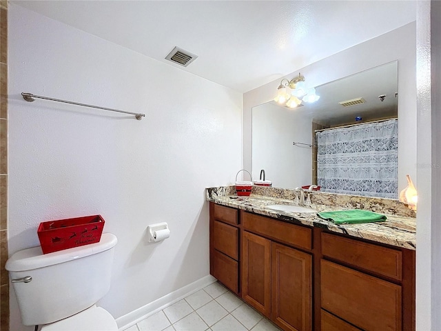 bathroom featuring vanity, tile patterned flooring, toilet, walk in shower, and a chandelier