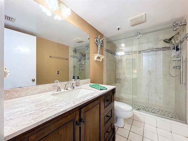 bathroom featuring tile patterned flooring, vanity, toilet, and a shower with shower door