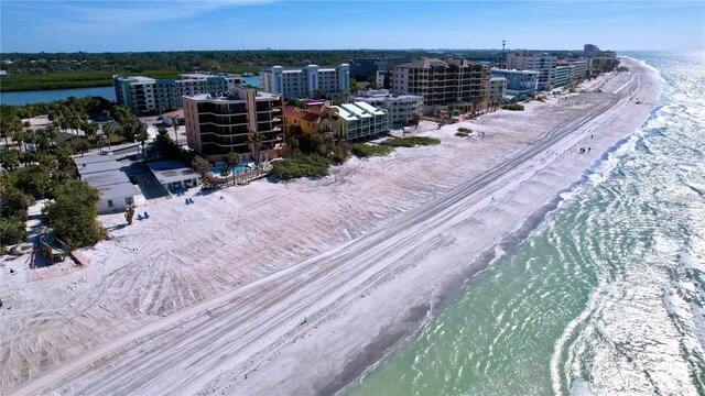 birds eye view of property with a water view and a beach view