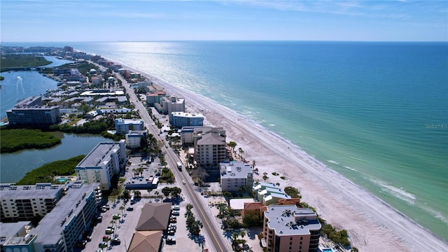 birds eye view of property featuring a beach view and a water view