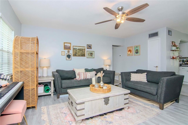 living room featuring ceiling fan and light hardwood / wood-style flooring