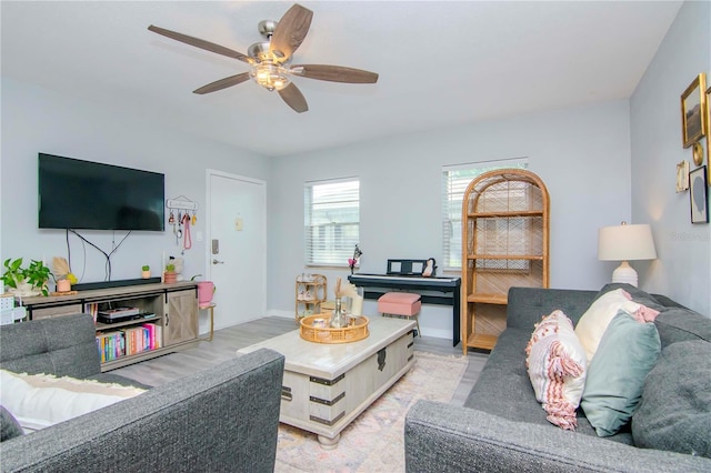 living room featuring ceiling fan and light hardwood / wood-style floors