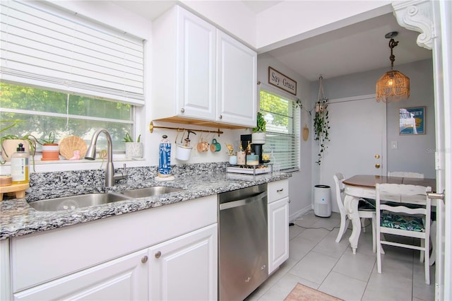 kitchen featuring dishwasher, sink, light tile patterned floors, pendant lighting, and white cabinets