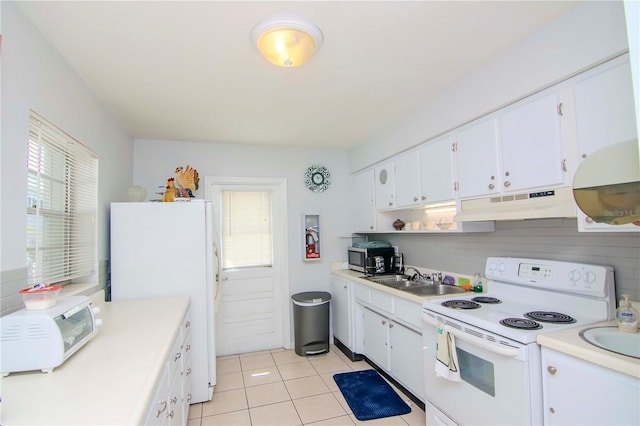 kitchen with sink, white cabinets, light tile patterned flooring, and white appliances