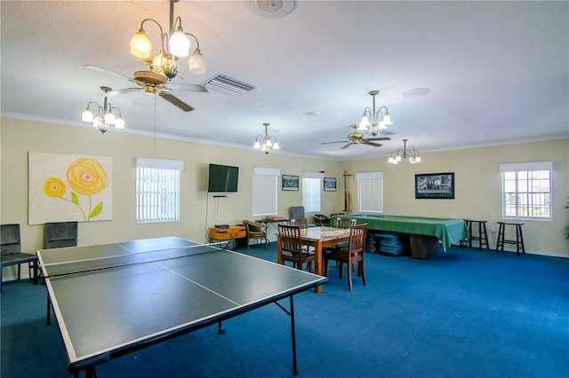 playroom with ceiling fan with notable chandelier, ornamental molding, carpet, and visible vents