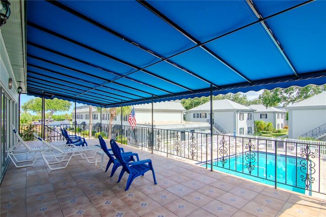 view of patio with fence, a residential view, and a fenced in pool