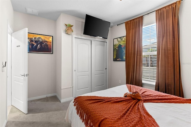 carpeted bedroom featuring a closet