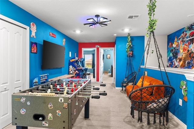 rec room with light carpet and ceiling fan