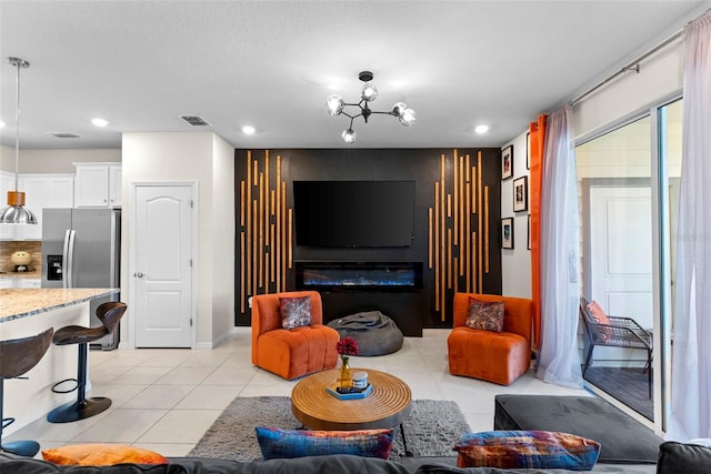 living room featuring light tile patterned floors and an inviting chandelier