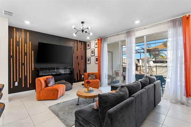 tiled living room with a notable chandelier