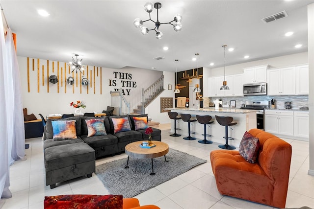 tiled living room with a chandelier