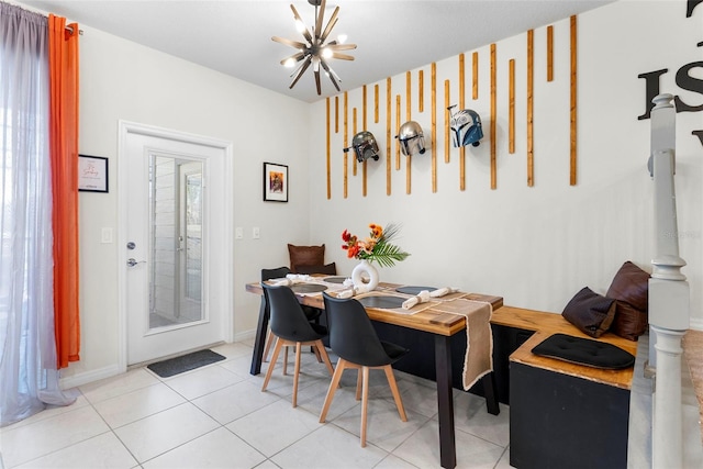 dining space with plenty of natural light, light tile patterned floors, and an inviting chandelier