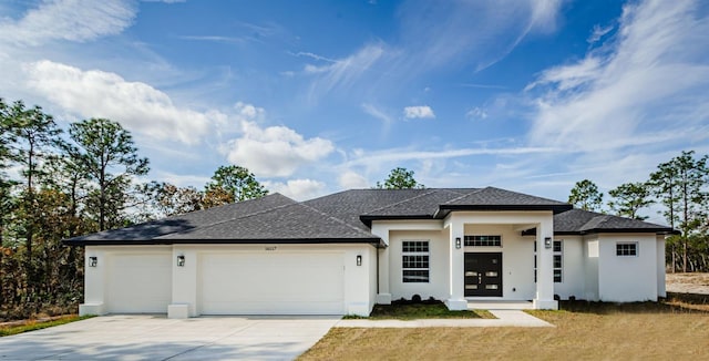 prairie-style house with french doors and a garage