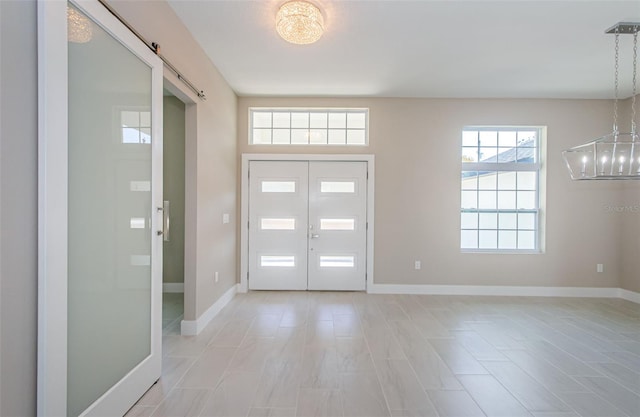 entrance foyer with french doors and a barn door