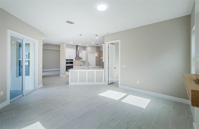 unfurnished living room featuring sink