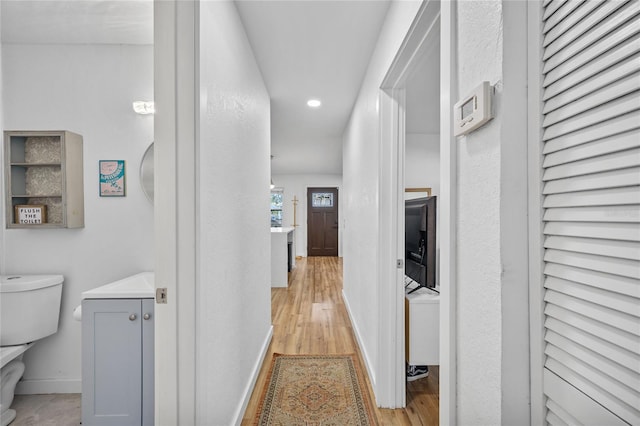 hallway with light hardwood / wood-style flooring