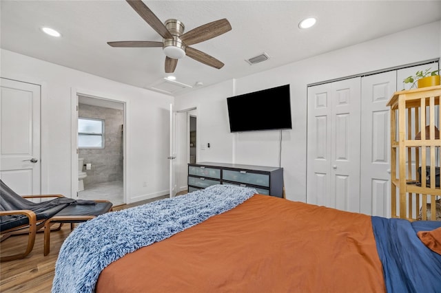 bedroom featuring ceiling fan, light hardwood / wood-style floors, connected bathroom, and a closet