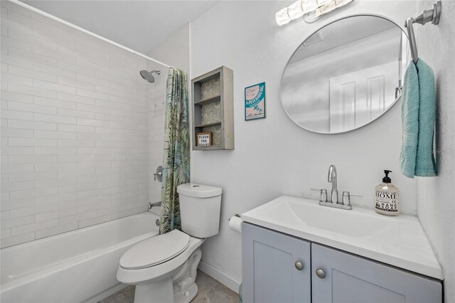 full bathroom featuring tile patterned floors, shower / bathtub combination with curtain, vanity, and toilet