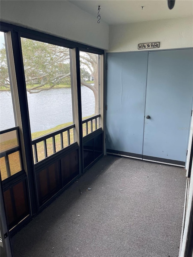 unfurnished sunroom with a water view and a wealth of natural light