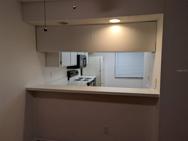 kitchen with white appliances, light countertops, and white cabinets