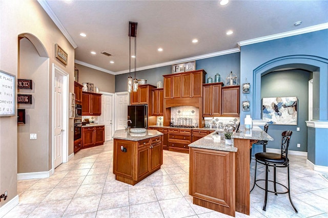 kitchen with a kitchen breakfast bar, ornamental molding, tasteful backsplash, a kitchen island, and kitchen peninsula