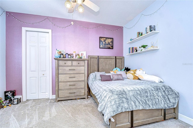 carpeted bedroom featuring a closet and ceiling fan