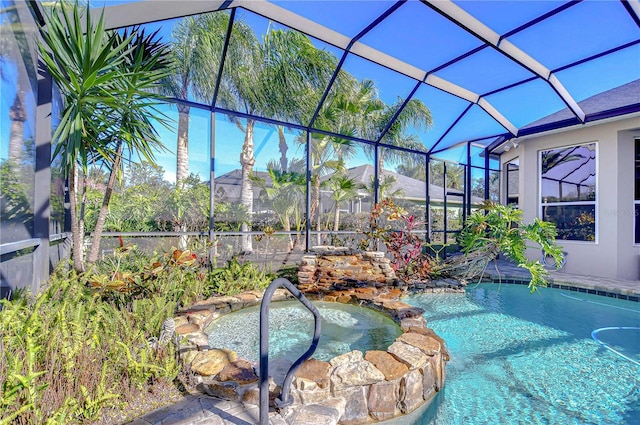 view of pool with a lanai, a garden pond, and an in ground hot tub