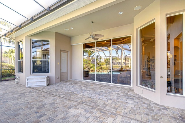 view of patio featuring ceiling fan and a lanai