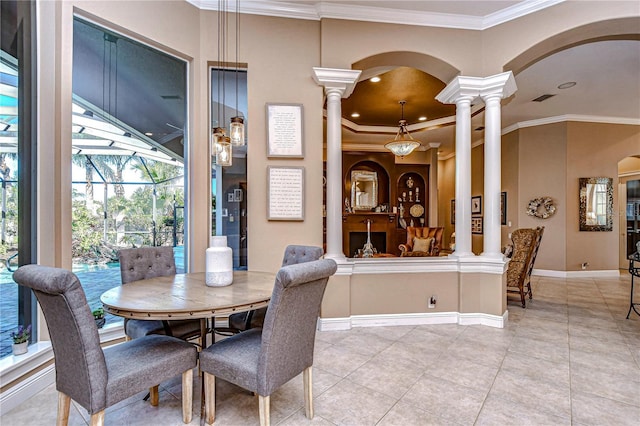 dining room with decorative columns, ornamental molding, and light tile patterned flooring