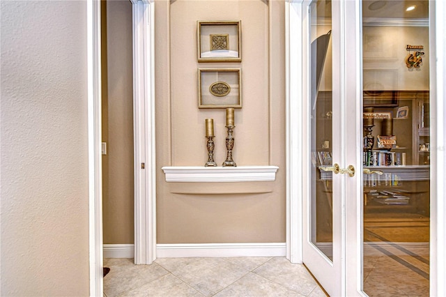 interior space featuring french doors, tile patterned floors, and crown molding