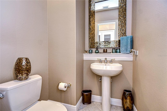 bathroom with tile patterned flooring and toilet