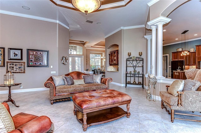 living room featuring light tile patterned floors, decorative columns, and ornamental molding