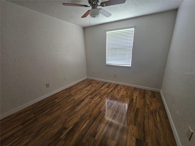 spare room featuring ceiling fan, dark hardwood / wood-style flooring, and a textured ceiling