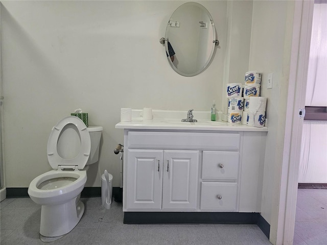 bathroom featuring tile patterned flooring, vanity, and toilet