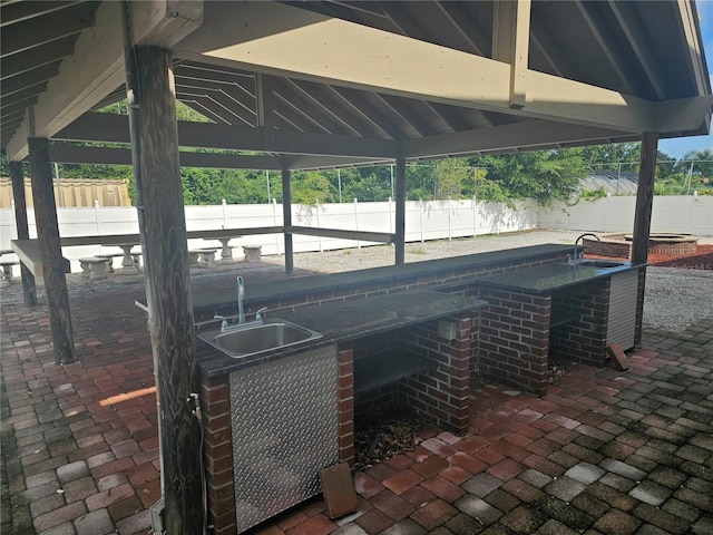 view of patio / terrace with a gazebo and sink