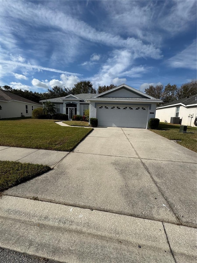 single story home with a garage and a front yard