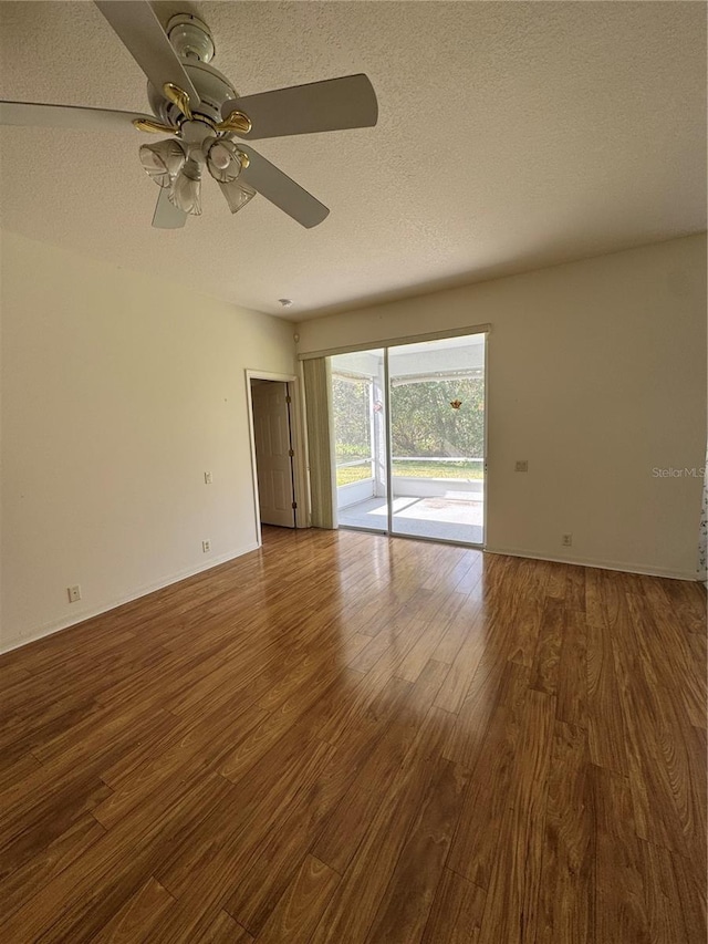 empty room with ceiling fan, a textured ceiling, and hardwood / wood-style flooring