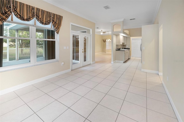 interior space with ceiling fan, light tile patterned floors, and crown molding