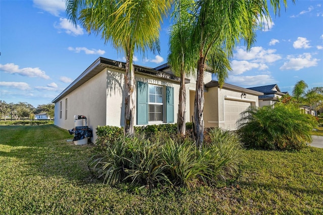 view of side of home featuring a yard and a garage