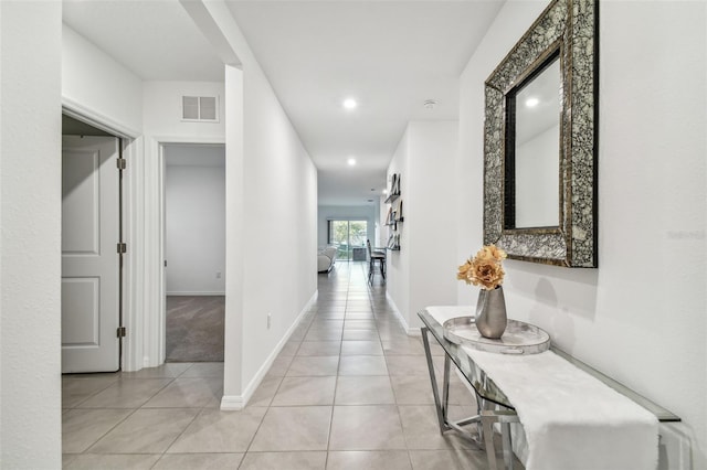 corridor featuring light tile patterned floors