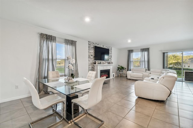 tiled dining space with a large fireplace