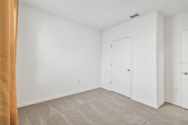 unfurnished bedroom featuring light carpet