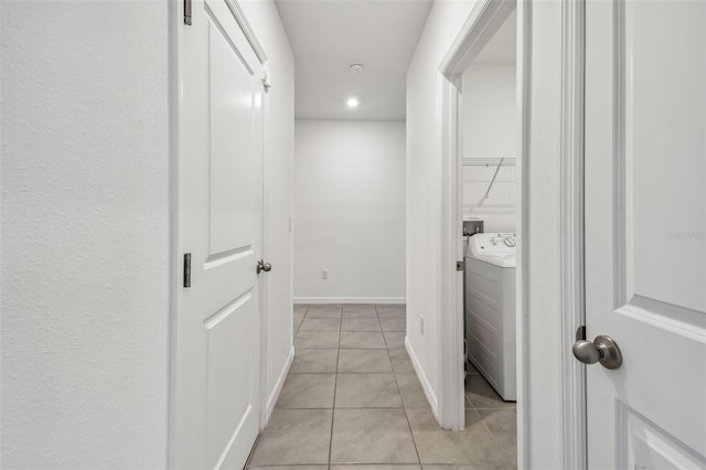 hallway with light tile patterned floors and washer / clothes dryer