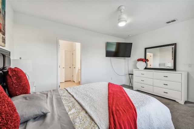 bedroom featuring light colored carpet and connected bathroom